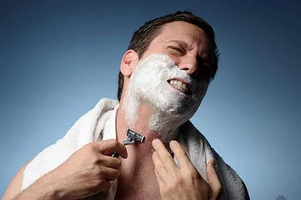 Man Shaving With Razor Burn how to get rid of shaving bumps