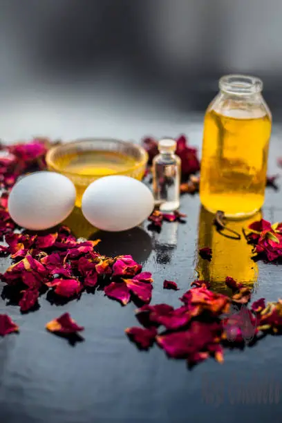 Trio pack of herbs and ingredients to fight dandruff on the wooden surface well mixed in a glass bowl which are castor