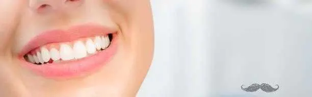 Young woman. Smiling mouth with white teeth. Closeup. Front view. Dental banner. Empty place for text quote saying or