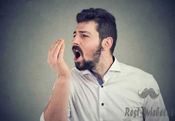 man doing a hand breath test best toothpaste for bad breath